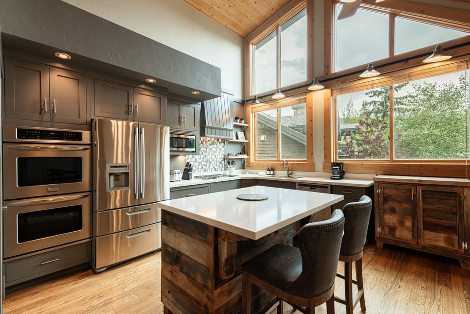 Fully equipped kitchen and stainless steel appliances, including a wine fridge
