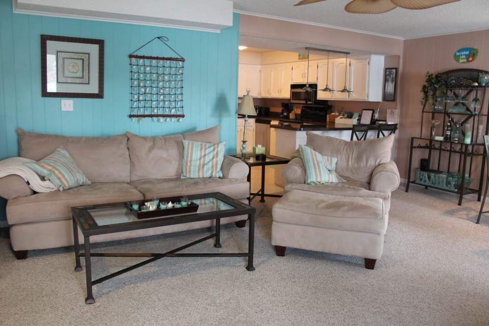 Open living area between kitchen and living room which goes directly to patio.