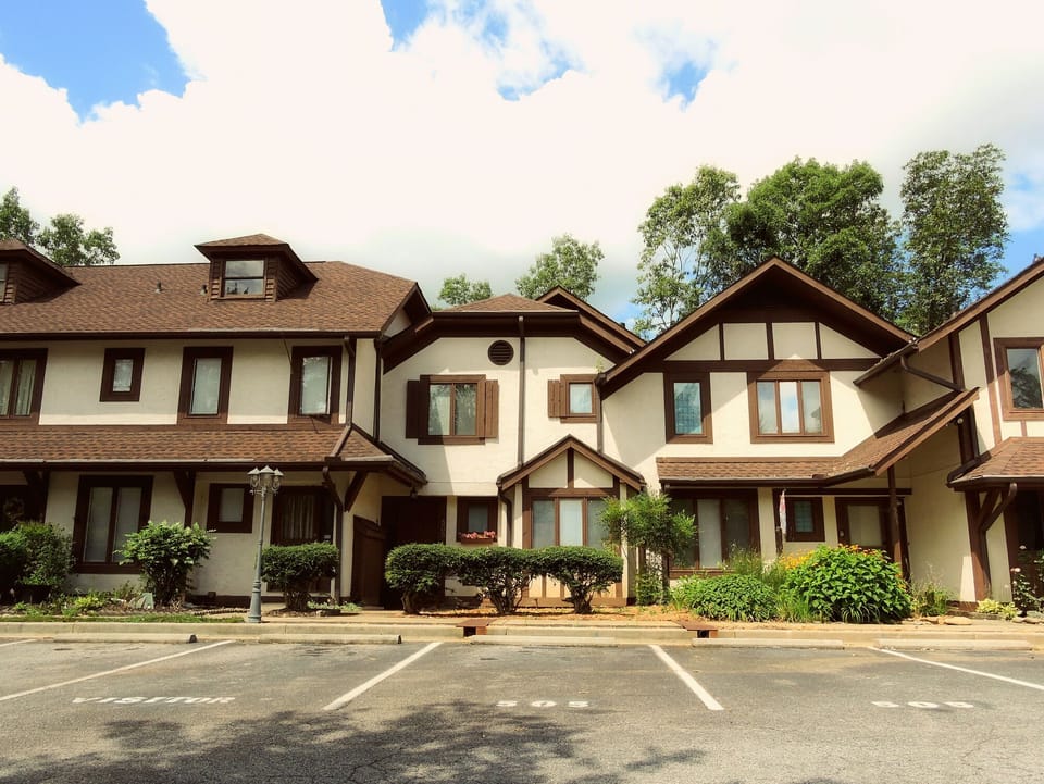 Front view of the condo with marked parking spaces