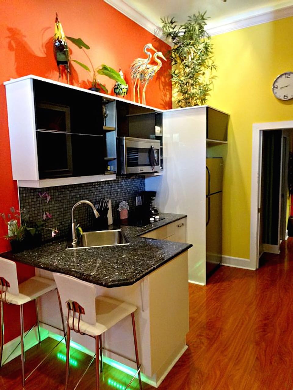 Galley style kitchen, granite counters, stainless steel appliances, 2 barstools