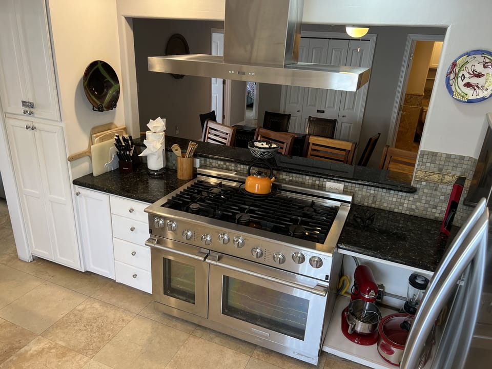 Gourmet dual fuel commercial range has six gas burners and convection ovens