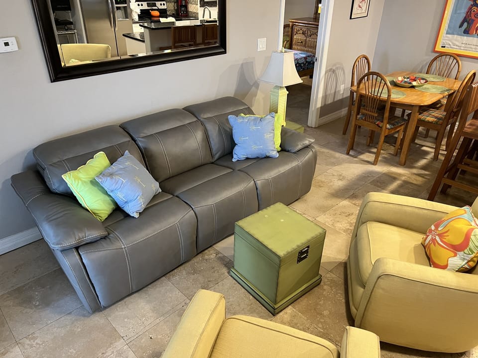 Comfortable luxurious leather sofa. Entrance to master bedroom   