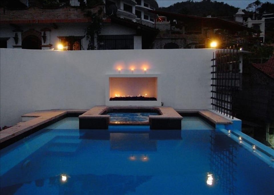 Private pool & Jacuzzi at night with the fireplace
