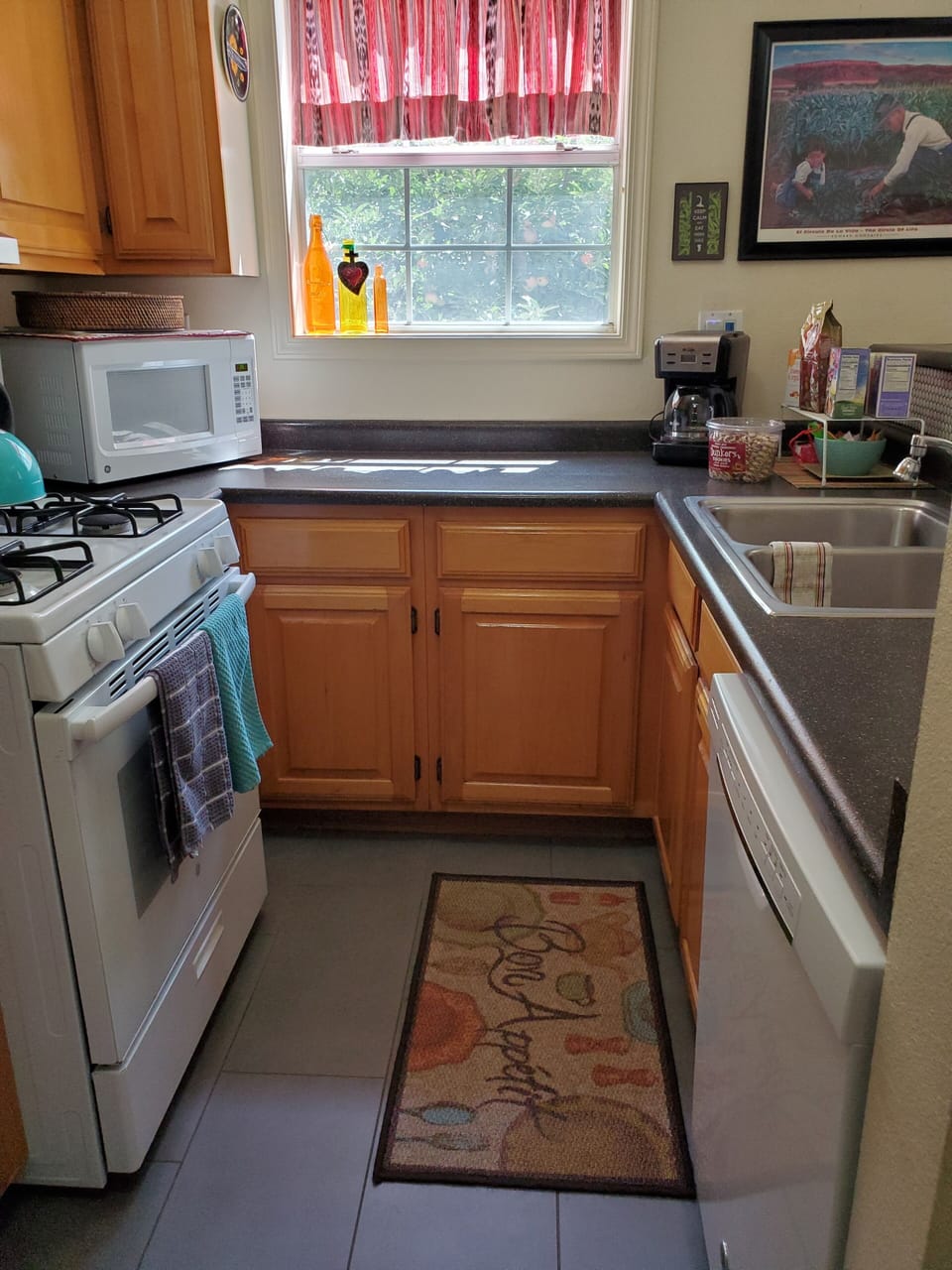 Kitchen with gas stove, micro, DW, refrigerator.  