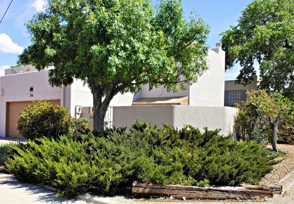 Private corner two story townhome with two car garage steps from Old Town.