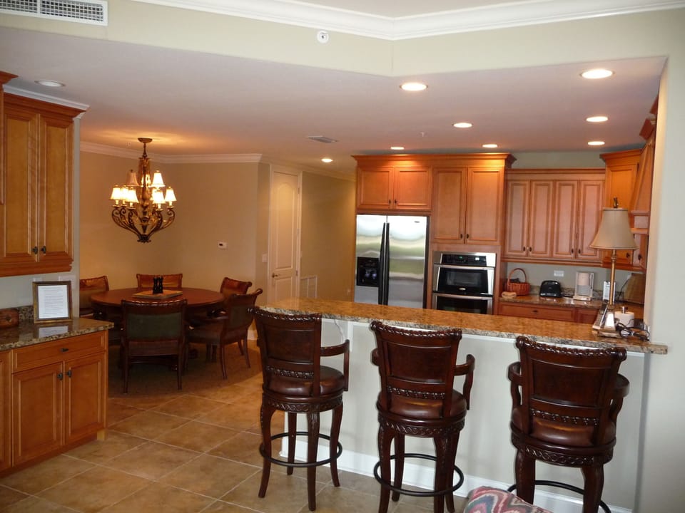 View of kitchen, dining room, breakfast bar, and wine cabinet