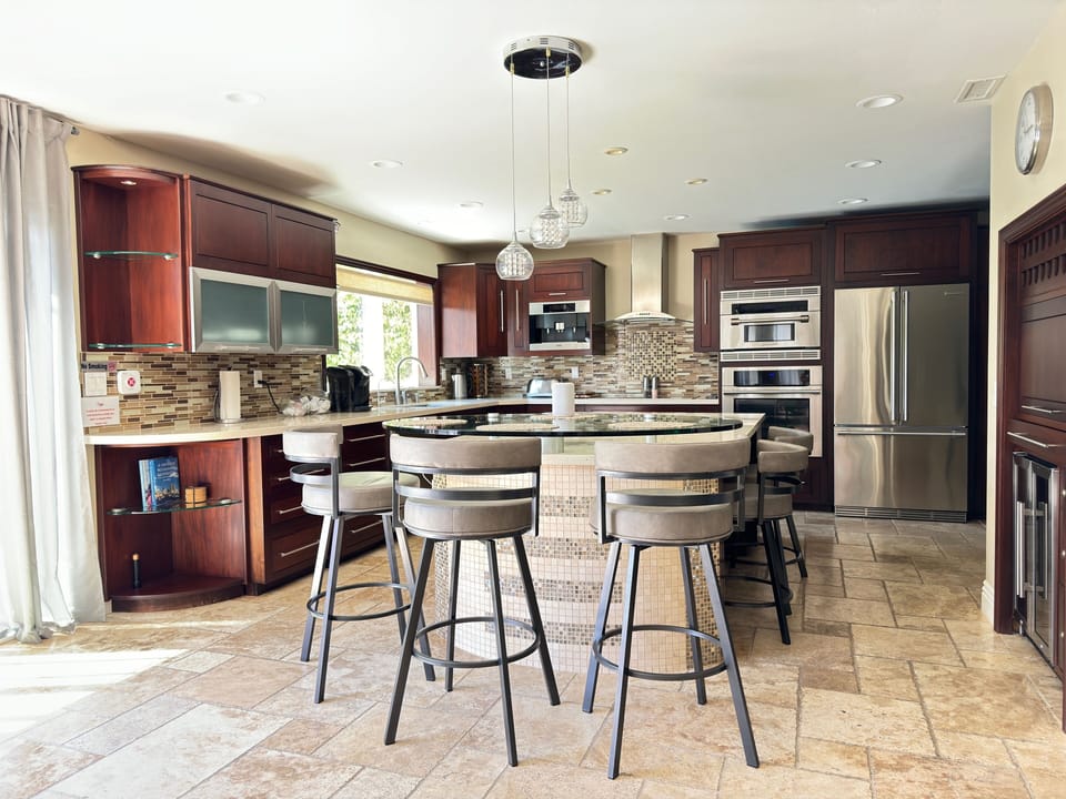 Glass-top island bar table, perfect for dining and entertaining.