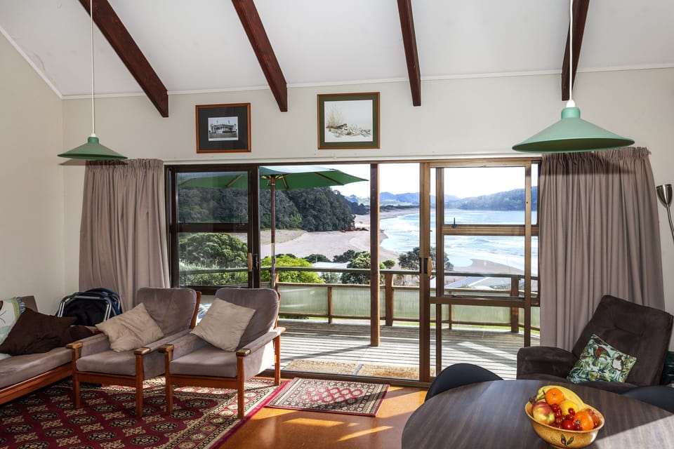 Open plan living and dining area with views out over the beach and sea
