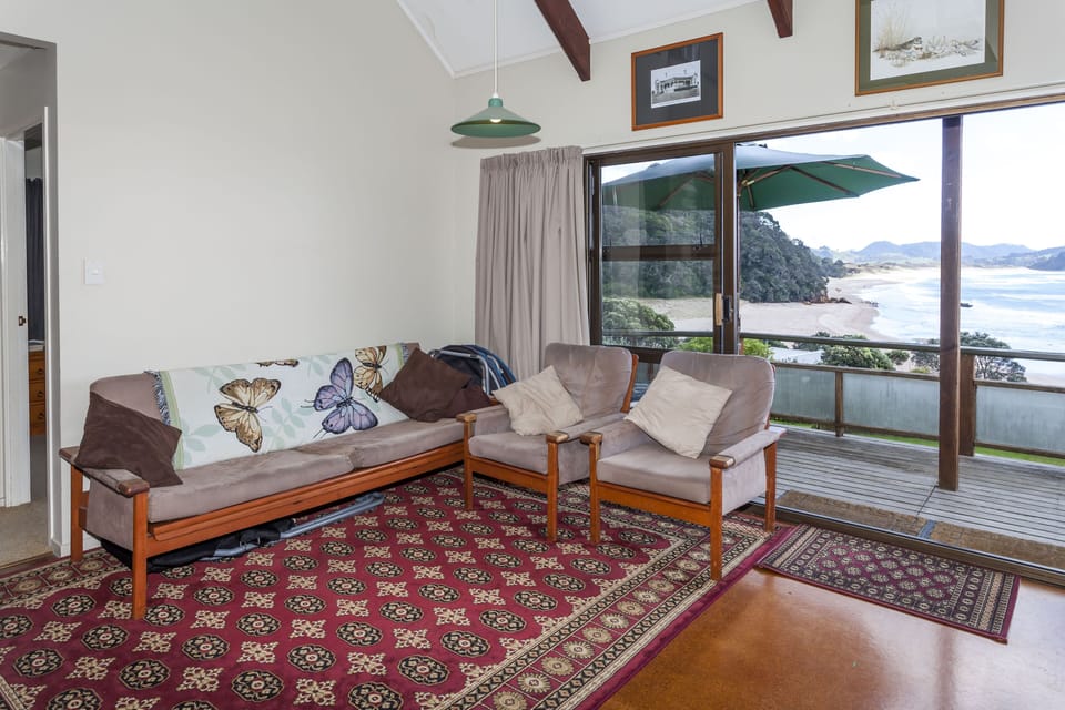 Open plan living and dining area with views out over the beach and sea