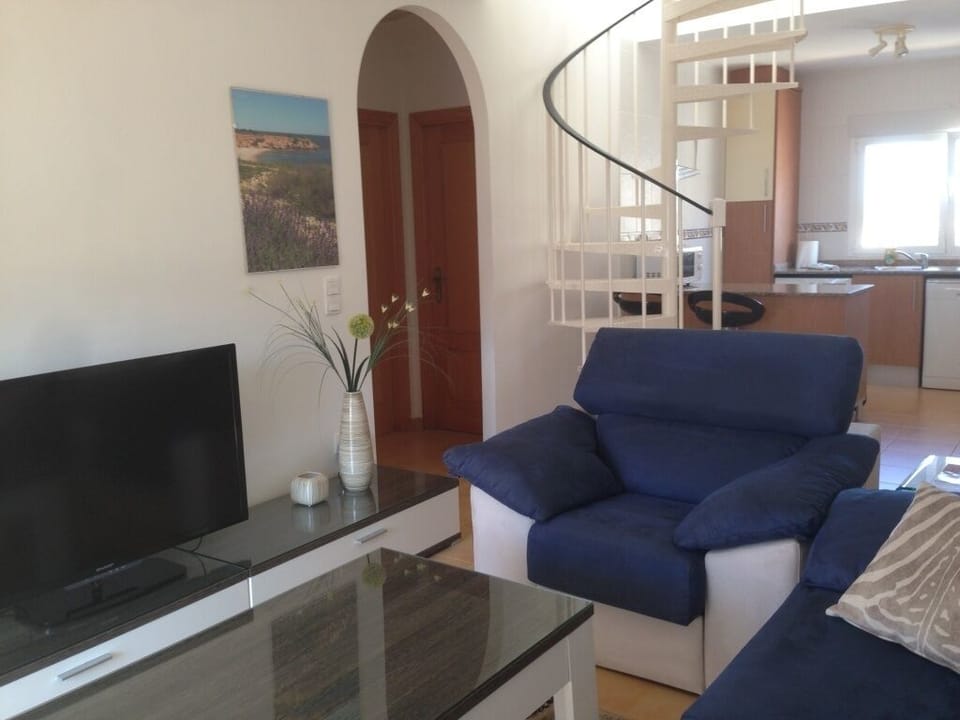 An open plan design living area, stairs to the upper floor