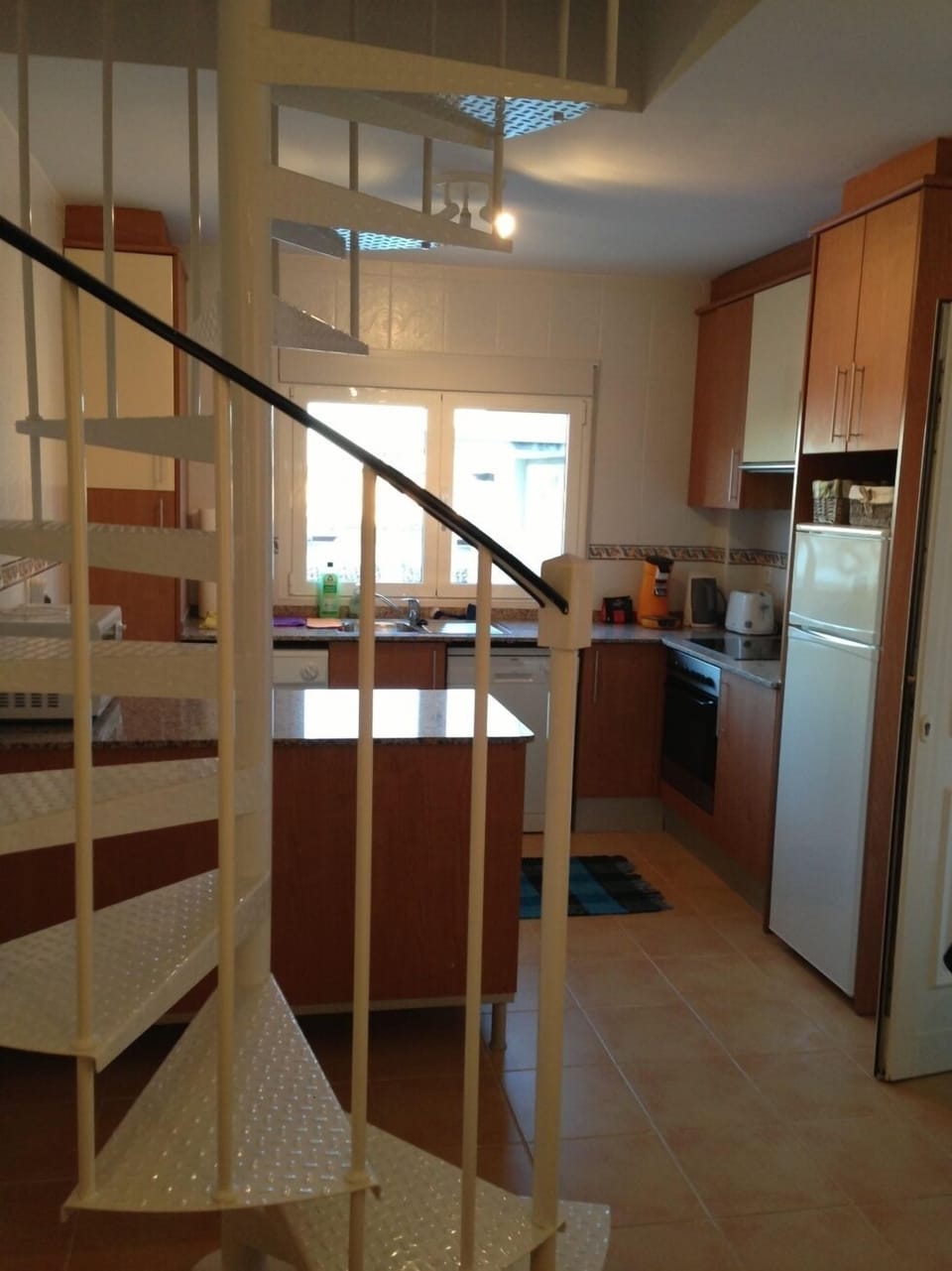 An open plan design living area; a view into the kitchen