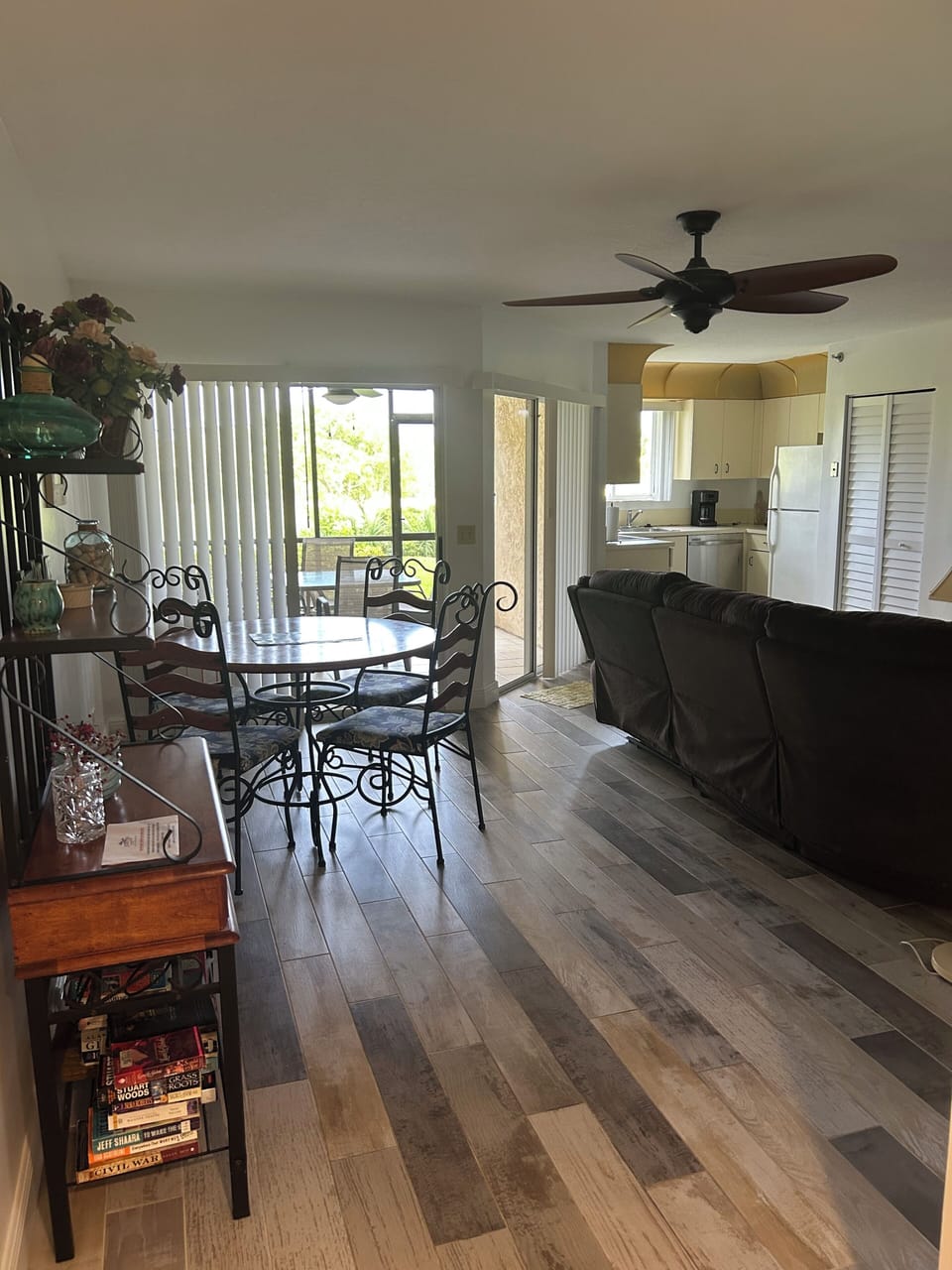 View of dining area, living room to the right, kitchen, and lanai in background 