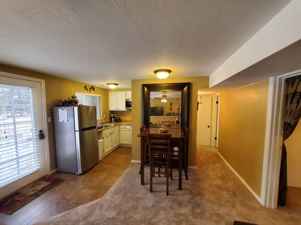 Dining area, full size refrigerator, 2 burner cooktop. 