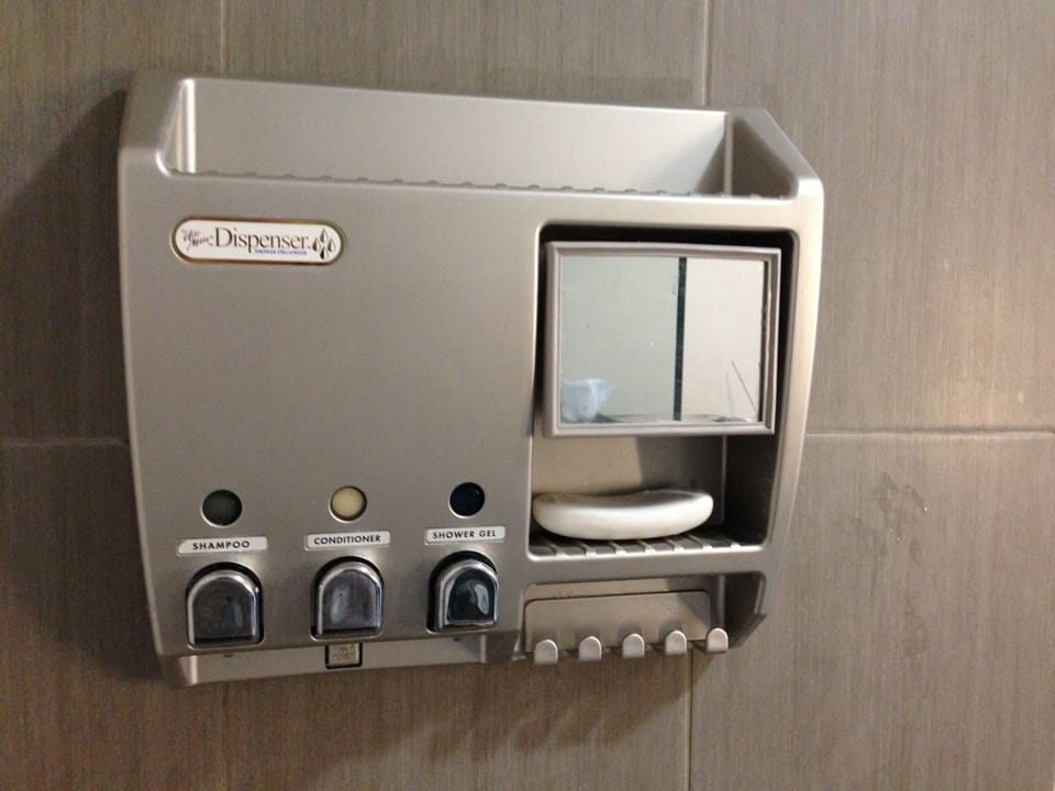 Shower soap dispenser with body wash, shampoo and hair conditioner.