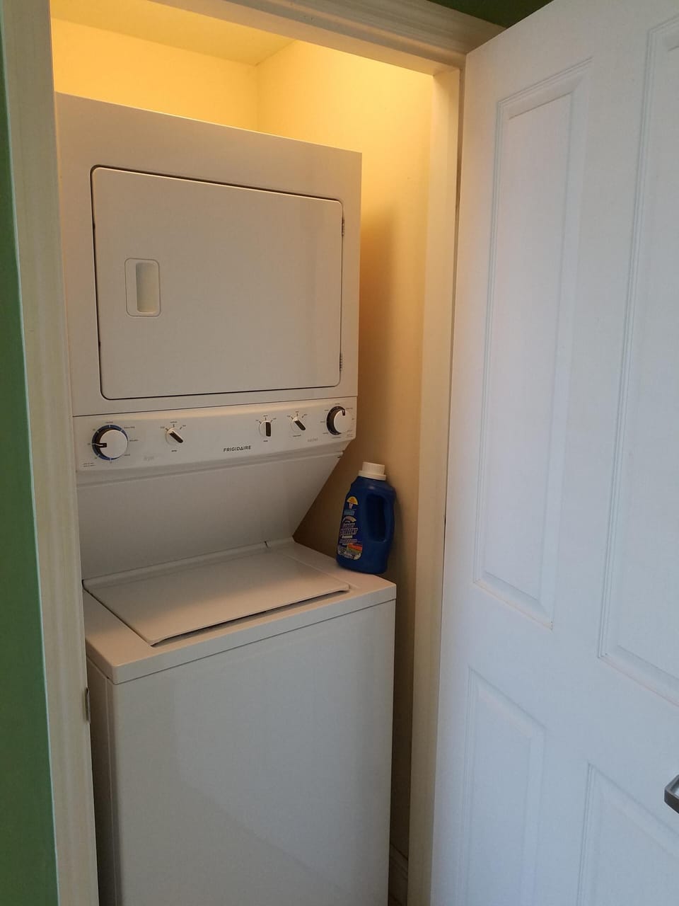 The full size washer and dryer room next to kitchen inside of the condo