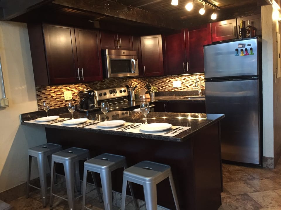 Kitchen, with bar seating for 4.