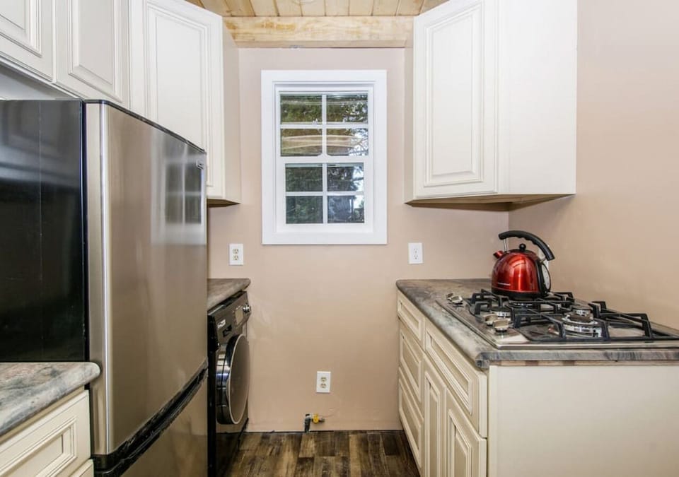 A large refrigerator, convection oven/toaster, and gas cook top are the recipe for the perfect meal.