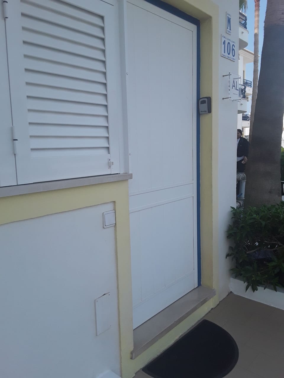The apartment front door with lock keys. 
