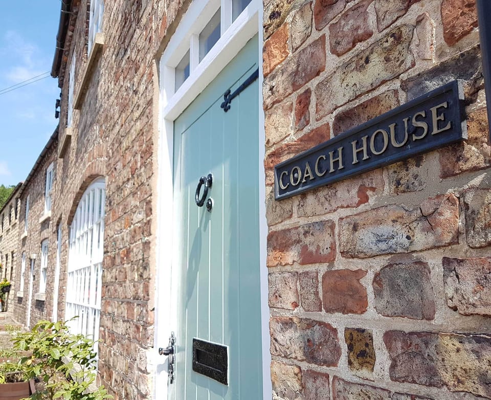 The Coach House converted cottage. With roses in planters