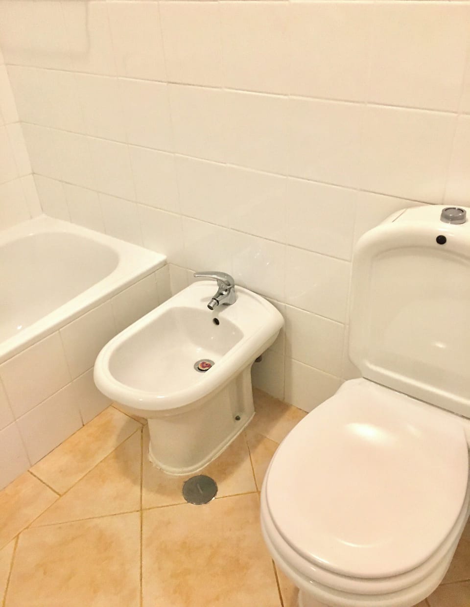 Part of bathroom with bath shower, sink, bidet and toilet 