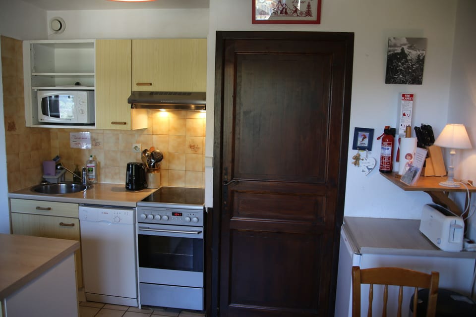 Part of the kitchen -- door leading to bathroom , bunk beds & corridor door .