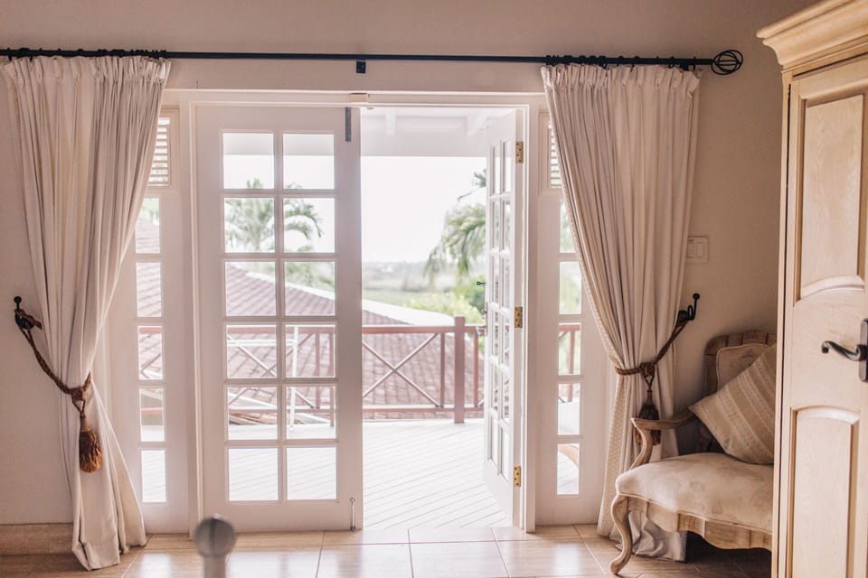 View from upper Master suite out to private deck overlooking pool and gardens