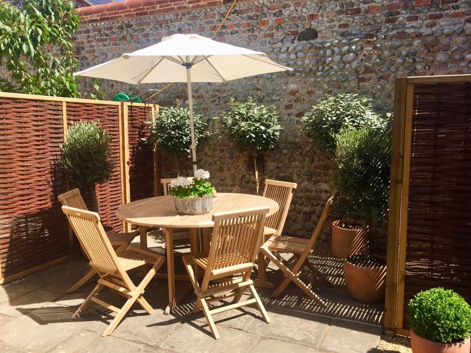 Terrace with table, chair & parasol plus barbecue. Sun trap and out of wind! 