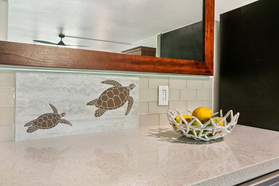 Elegant stone countertops featuring charming sea turtle tile work and high-end finishes.