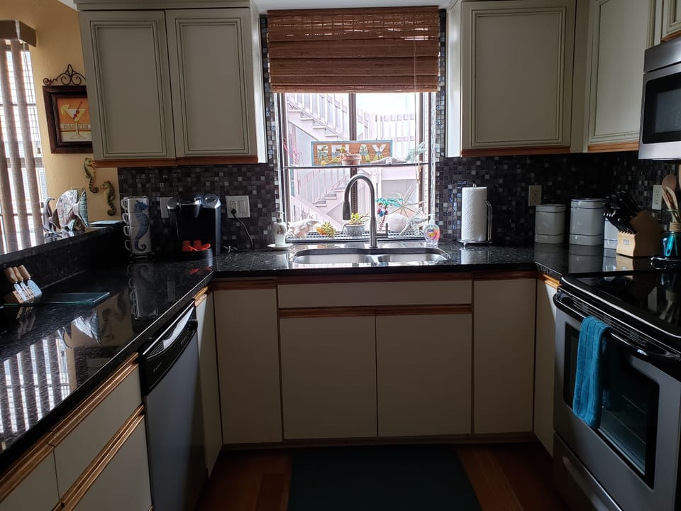The kitchen is equipped with all stainless steel appliances.