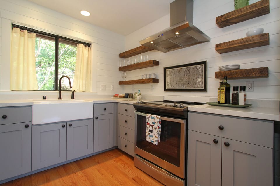 Farm sink, open shelves, lots of cupboards and countertop space