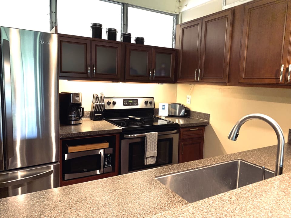 Kitchen with stove, oven, microwave and refrigerator