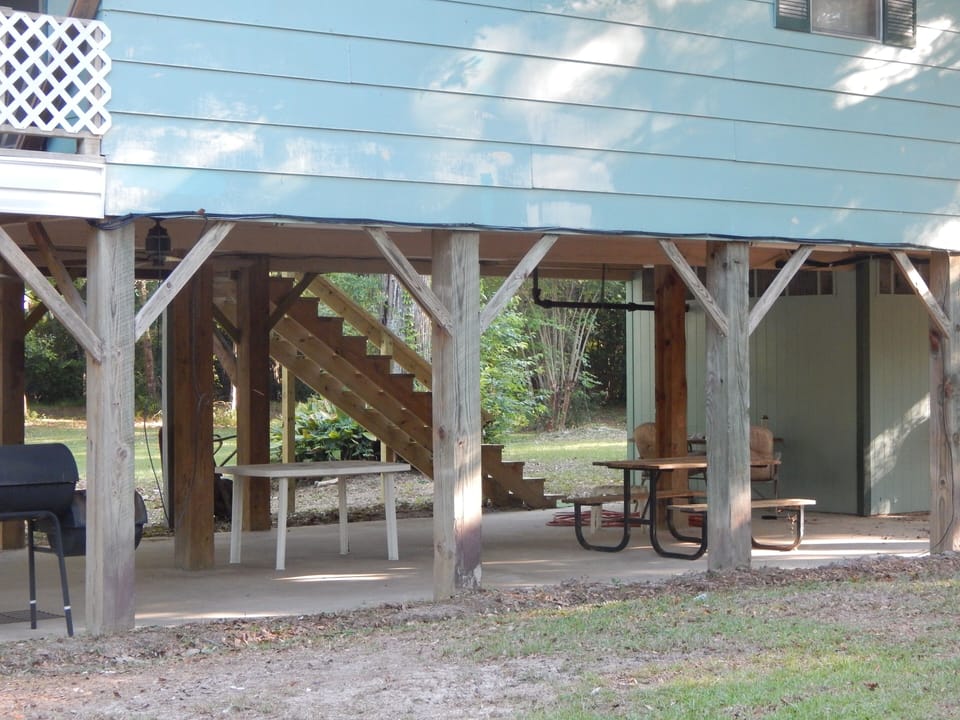 Concrete slab underneath house for gathering ceiling fans, power outlets, grill
