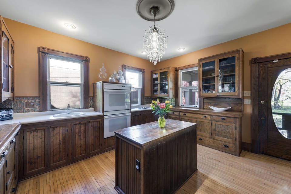 Main kitchen: Double oven, 5 burner stove, kitchen island, Fridge and microwave.