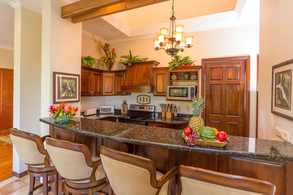 View of Kitchen flooded with natural sunlight from vaulted ceiling 25' above.  