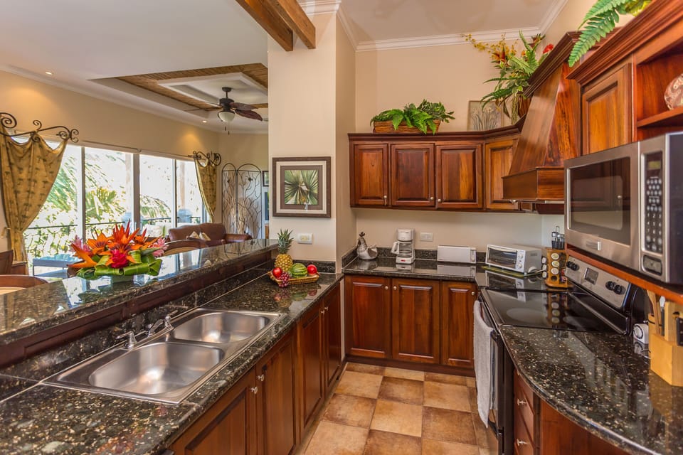 View of Kitchen w/granite counters, stainless appls. Dishes & cookware galore. 