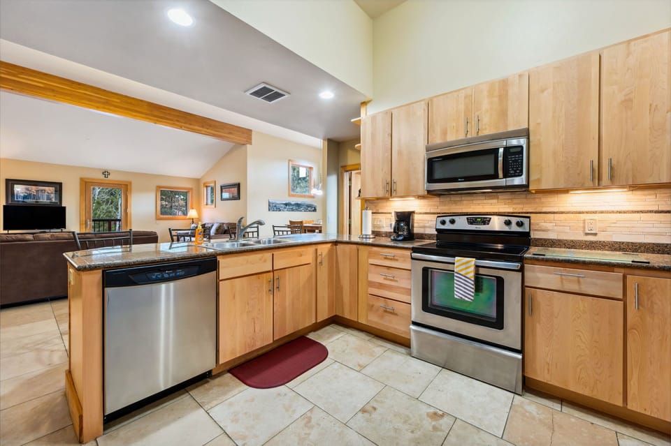 Stainless steel appliances with a glass cooktop and a new Bosch dishwasher.