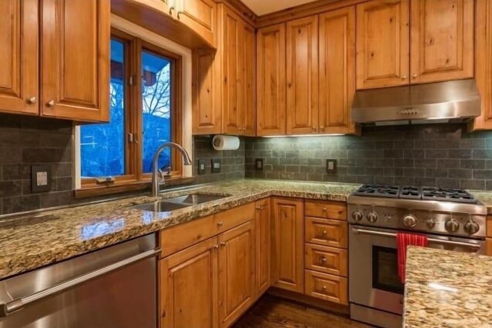 Close Up Kitchen Range and Sink.  Property has a microwave built into the island