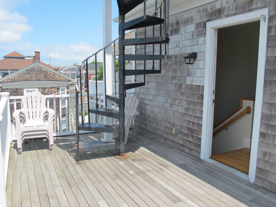Third floor balcony off of the master suite; spiral staircase to the roof deck