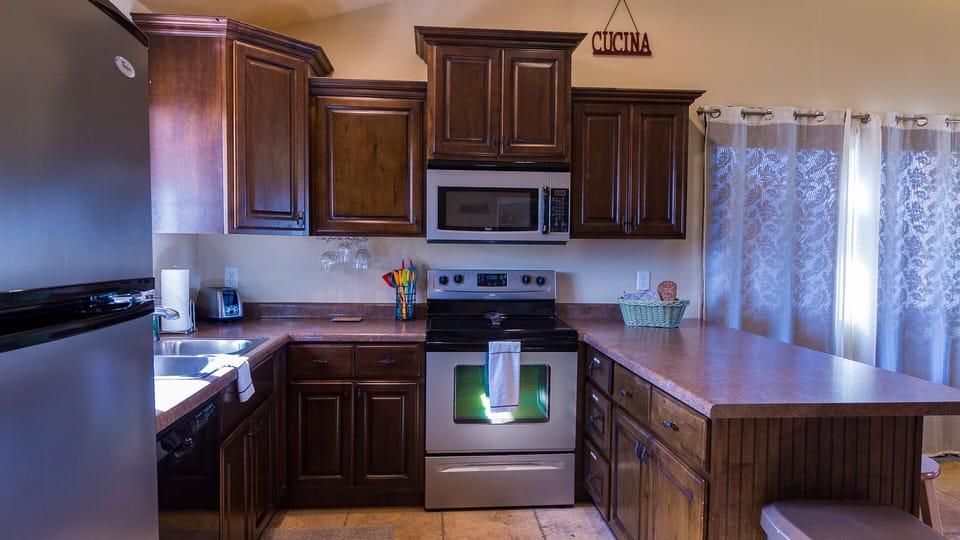 Kitchen Stocked With All Cookware And Dishes Needed To Prepare Your Meals 