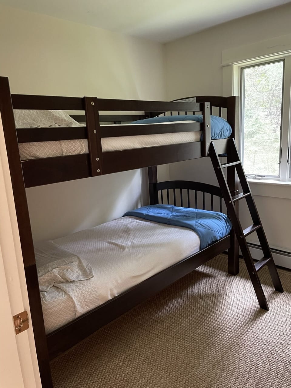 Second bedroom is cozy with twin bunkbeds.