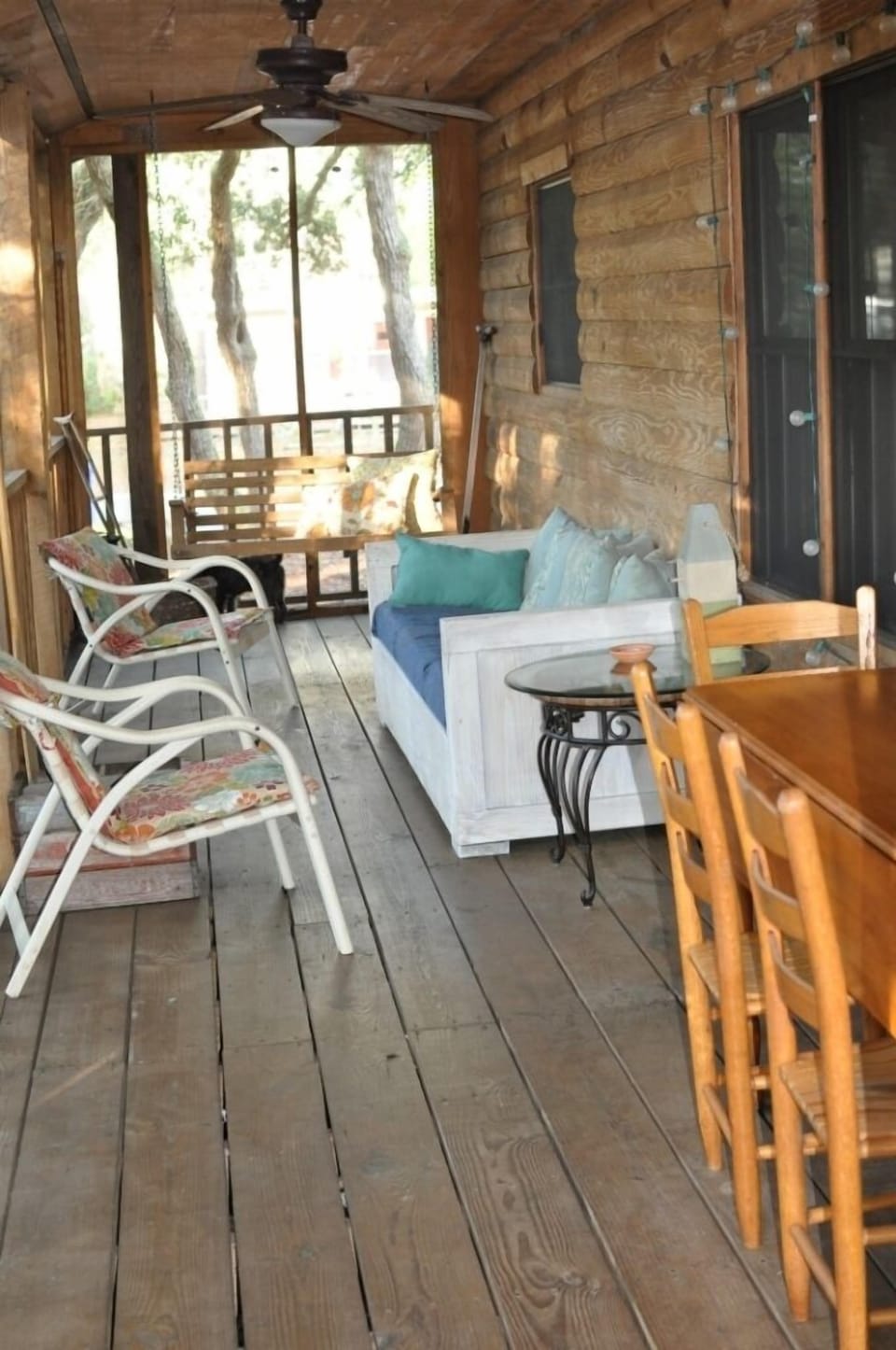 Screened in Porch with Couch, Swing, chairs and table