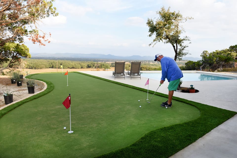 A four hole putting green with putters and balls provided