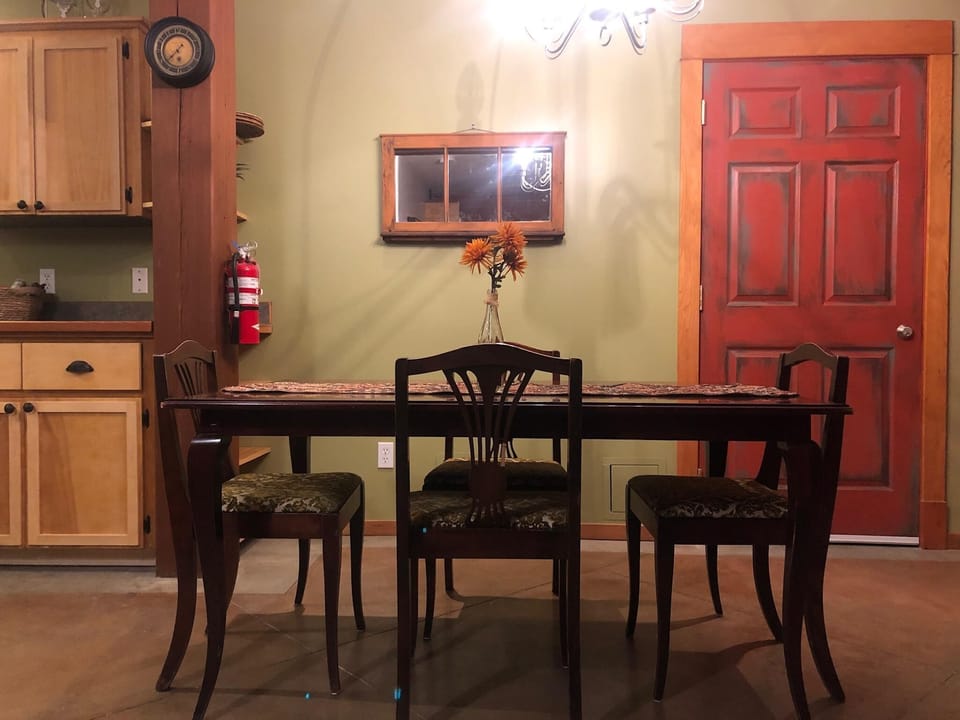 The open design of the dining room and kitchen creates a warm and inviting ambiance, perfect for casual family dinners or gatherings with friends. It encourages conversation and makes every meal a delightful experience.