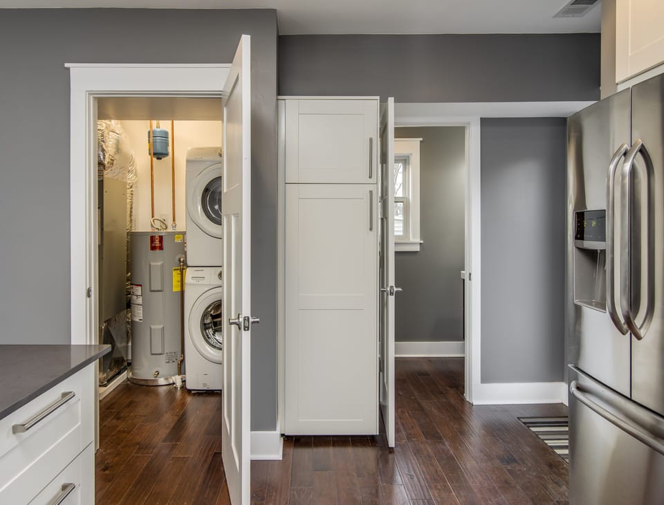 One of two laundry rooms! Plus a peak into the half bath.