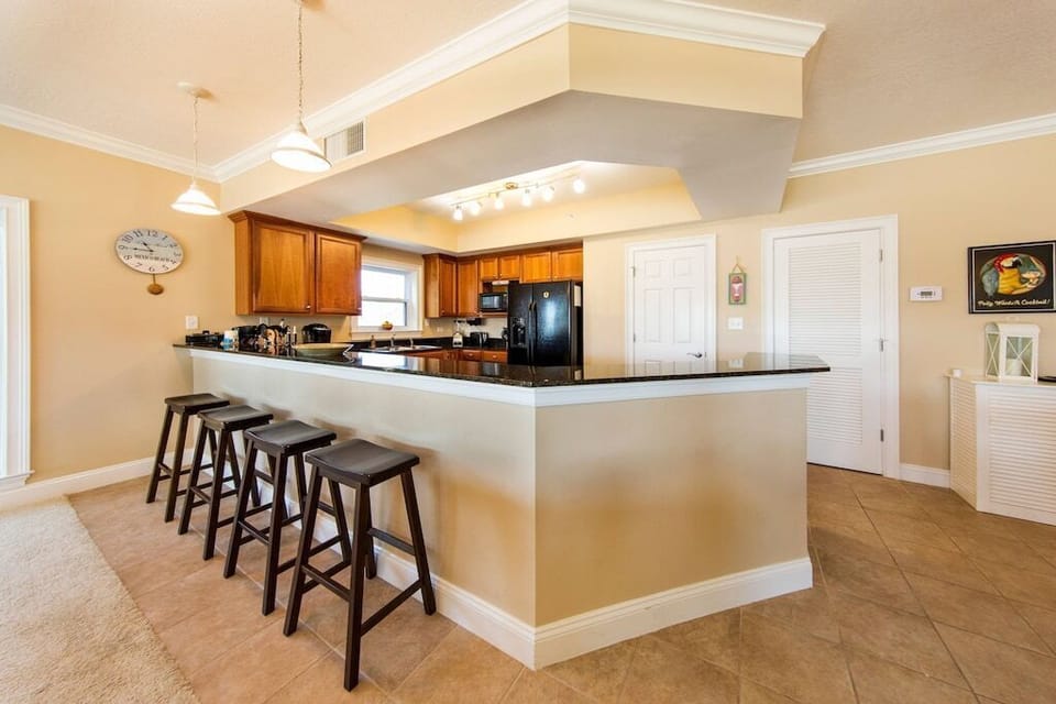 This cook's kitchen has spacious breakfast bar for extra seating