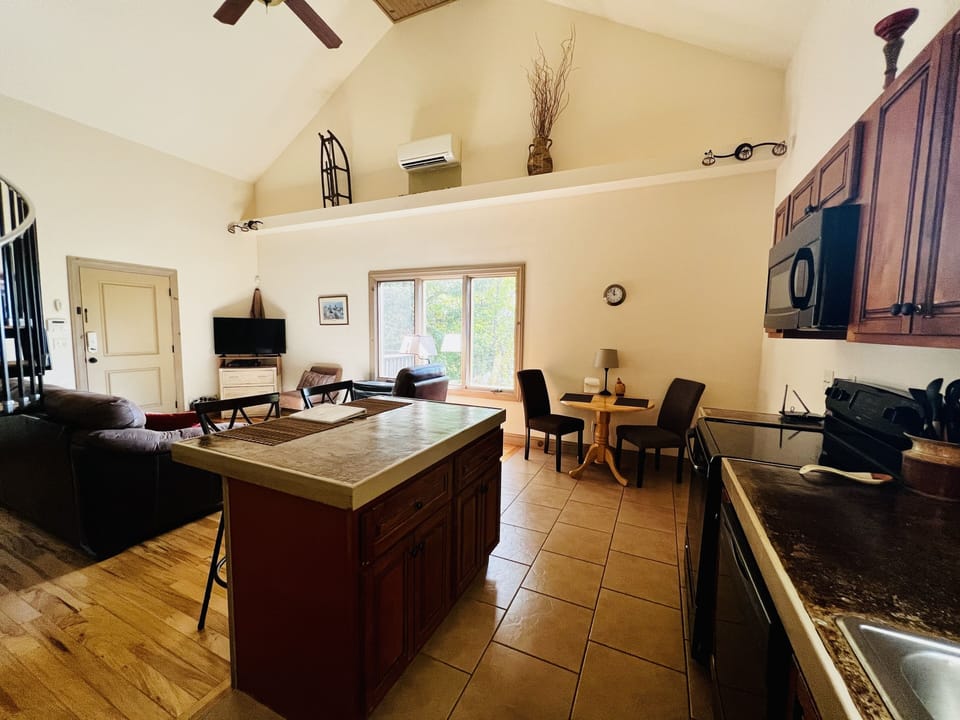Open floor Plan, Kitchen and living room. Small table in kitchen. 
