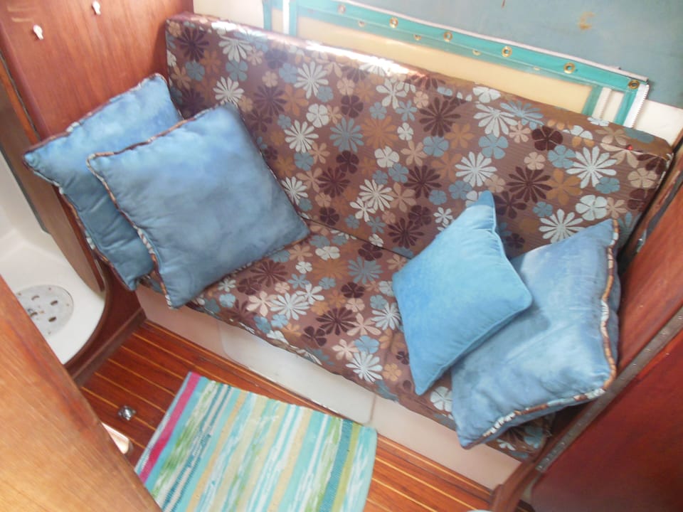 Settee at nav station offers place for kids and electronics or reading. 