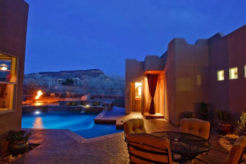 Night time at Sierra Bella with outside shower and half bath by pool/hot tub.