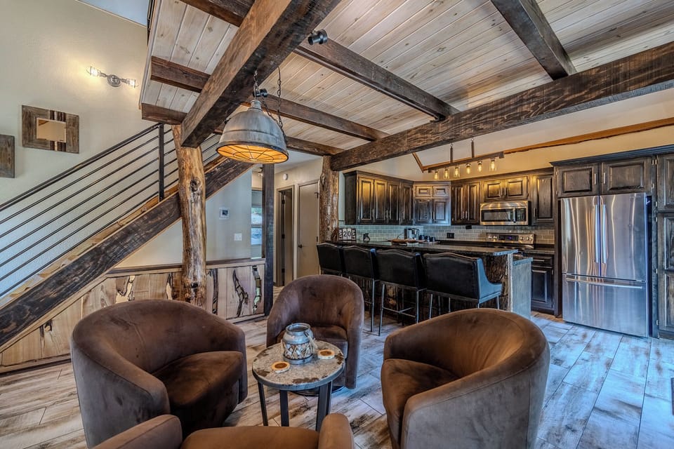 The area leads to the loft, main level bedrooms, bath, and downstairs.