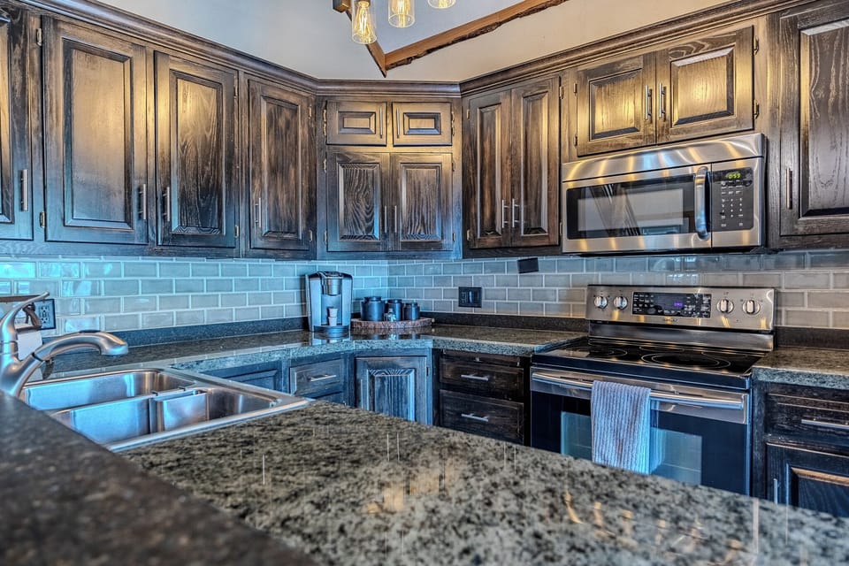 Modern kitchen with sleek countertops and stainless steel appliances.